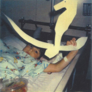 Child Holding Up Sea Horse at Hospital